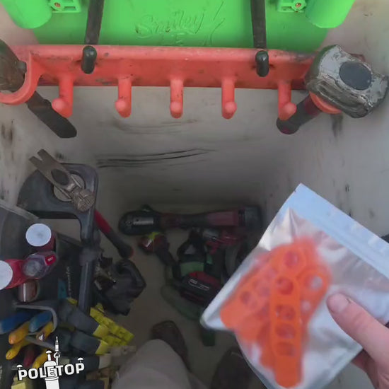 Installing a fresh pack of orange Hook Keepers on a bucket rack, then hanging tools off them
