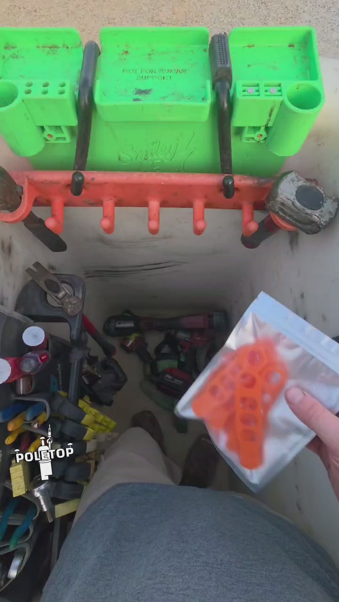 Installing a fresh pack of orange Hook Keepers on a bucket rack, then hanging tools off them